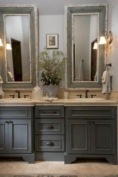 a bathroom with double sinks and two mirrors