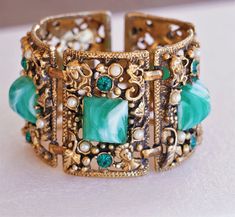 Selro Ornate Gold Wide Figural Faces Rhinestone Green Lucite Victorian Bracelet Smaller 6" Wrist This Extremely Chunky and Ornate Rich Gold Beauty features a Detailed Floral Setting with Ladies Heads in Each Corner. Large Green Marbled Lucite Stones adorn each Link along with Seed Pearls and Emerald Green Rhinestones. Fits Smaller Wrist 6" x 1 3/4" with Secure Clasp. Verified Selro Mint Vintage Condition!  Looks New and Unworn, More Gorgeous in Person! The Perfect Renaissance Bracelet! Face Rhinestones, Victorian Bracelet, Gold Beauty, Seed Pearl, Victorian Jewelry, Cuff Bracelets, Jewelry Bracelets, Bangles, Cuff