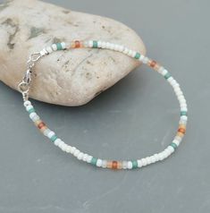 This seed bead surf bracelet has been lovingly made using frosted white, topaz, light topaz, seafoam green blue and Ivory white 3mm Miyuki glass seed beads.  Suitable for both men and women, this has the ultimate beach look and perfect for holidays and everyday. Threaded on strong stainless steel 7 strand Tiger Tail wire and finished with silver plated wire guardians, and a trigger clasp and optional extender chain. Matching Necklace available at: https://crafthutcornwall.etsy.com/listing/146489 Need Bracelet Ideas, Beach Seed Bead Bracelets, Sea Beads Bracelet Ideas, Beach Beads Bracelets, Seed Bead Jewelry Diy Bracelets, Surf Jewelry Bracelet, Cute Beachy Bracelets, Beachy Bracelets Diy, Small Glass Bead Bracelet Ideas