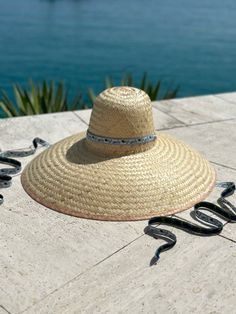 The extra-wide brim sun hat is woven, like a basket, with dried palm tree leaves. Then it is shaped with the same antique hat mold we use to shape our Daisy sun hat.  This super wide-brimmed hat will glamorously shield you from the sun. The Geranium is woven with wider pieces of palm leaf vs. The Daisy is woven with fi Artisan Hats For Beach And Kentucky Derby, Curved Brim Straw Hat For Sunbathing, Woven Palm Leaf Boater Hat With Wide Brim, Handwoven Toquilla Straw Sun Hat With Curved Brim, Wide Brim Palm Leaf Sun Hat For Beach Season, Woven Wide Brim Boater Hat From Palm Leaf, Handwoven Palm Leaf Straw Hat For Summer, Vacation Wide Brim Straw Hat Made From Palm Leaf, Coastal Style Woven Straw Hat With Wide Brim