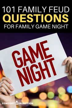 a person holding up a game night sign with the words game night written on it