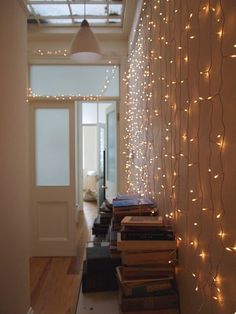 a hallway with books and lights on the wall