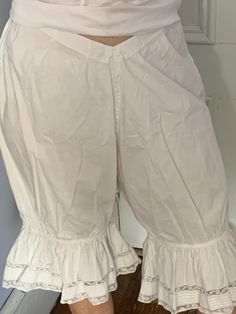 1900's cotton bloomers with lace trim at legs, drawstring at waist and side button.  Found in France.  In excellent condition.  Refer to all photos, selling as found. Measures: Waist:  32" Hips:   up to 58" Length:  29" Fitted Vintage Bottoms With Ruffles, Daywear Cotton Bloomers With Ruffles, Cotton Bloomers With Ruffles For Daywear, White Cotton Cottagecore Bottoms, Cotton Cottagecore Bottoms For Summer, Cottagecore Cotton Bottoms For Summer, Vintage Ruffled Bottoms For Spring, Spring Vintage Ruffled Bottoms, Vintage Cotton Bottoms For Daywear