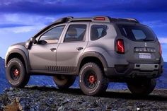 an suv parked on top of a rocky hill