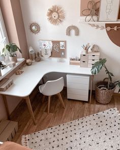 a white desk sitting next to a window in a room filled with furniture and decor