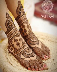 the feet are decorated with henna designs