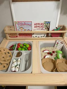 a wooden table topped with trays filled with food