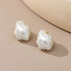 Beautiful Quality Costume Jewelry. Irregular Shaped Large Pearl Stud Earrings. Gold Colored Setting And Back Plate. Brand New. 0.6 X 0.8 Inches. Trendy White Drop Pearl Earrings, Trendy White Pearl Drop Earrings, Chic White Metal Earrings, Trendy White Wedding Earrings, Chic White Clip-on Earrings Gift, Chic White Clip-on Earrings For Gift, White Chic Clip-on Earrings For Gift, Trendy White Pearl Earrings For Formal Occasions, Trendy White Pearl Earrings