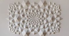 an abstract white paper sculpture on the wall