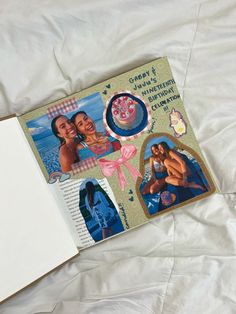 an open book sitting on top of a bed next to a white sheet with pictures