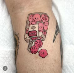 a person with a tattoo on their leg that has pink donuts coming out of it