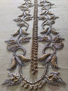 an intricately designed piece of cloth with silver thread