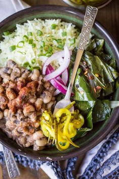 a bowl filled with rice, beans and vegetables