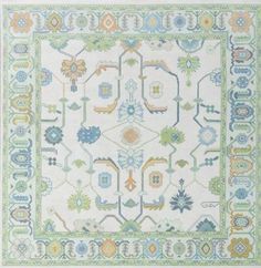 a white rug with blue, yellow and green designs