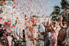 a group of people standing next to each other under confetti