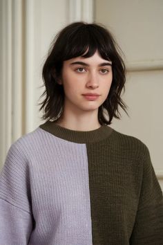 Person wearing a two-toned knit sweater in a neutral room. Shaggy Fringe Bob, Short Shaggy Hair, Shag Bob, Shag With Bangs, Shaggy Haircut, Shaggy Lob, Short Shaggy Bob, Curly Shag Haircut, Shaggy Bob Haircut