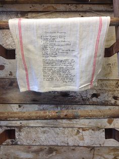 an old wooden chair with a towel hanging from it's back and writing on the side