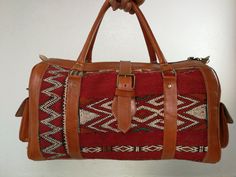 A beautiful Moroccan large weekender bag. very large and fits all important things and more made of leather and vintage Klim rug Inner slip pocket plus zippered pocket. Zip main compartment closure with buckled leather strap for additional style and security. Leather base, sides with buckle closure end pockets, and riveted handles. Measures: L(53) Cm x H(28) Cm x W(27) Cm L(20.6) inch x H(11) inch x W(10) inch I am happy to answer any questions Bohemian Duffle Bag For Overnight Trips, Bohemian Rectangular Duffle Bag For Overnight Trips, Bohemian Rectangular Duffle Bag For Weekend Trips, Bohemian Rectangular Bag For Overnight Trips, Bohemian Style Rectangular Duffle Bag For Weekend Trips, Bohemian Leather Rectangular Travel Bag, Bohemian Leather Travel Bag, Traditional Rectangular Duffle Bag For Travel, Bohemian Duffle Bag With Leather Handles