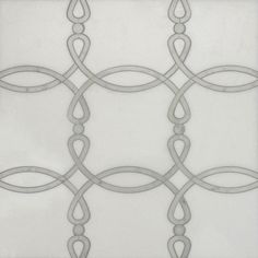 a white tile with silver lines and circles on the bottom, as well as an intricate design