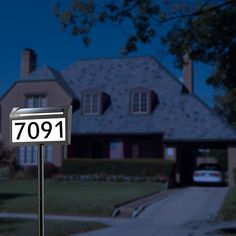 a mailbox in front of a house with the number 701 written on it