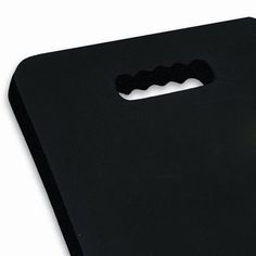 a black cutting board with a knife on it