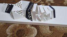 four pieces of paper are sitting on top of each other in the shape of an eiffel tower