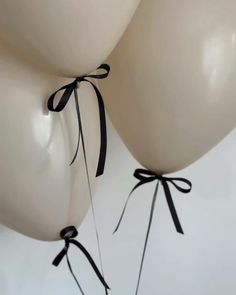 two white balloons tied to each other