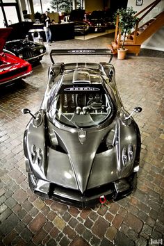 a silver sports car parked in a garage