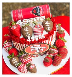 a cake with chocolate covered strawberries and footballs