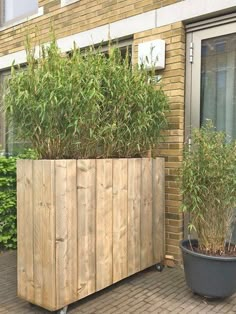 a wooden planter sitting next to a brick building