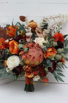 a bridal bouquet with orange and white flowers