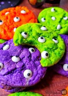 colorful cookies with googly eyes are on a table