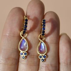 14K Gold 18 pieces 2 mm Sapphire｜Royal Blue｜Round｜SI Sapphire CTW: 0.90 12 pieces 2 mm Moonstone｜Blue｜Round｜SI 2 pieces 6 x 9 mm Moonstone｜Blue｜Pear｜SI Moonstone CTW: 3.40 Length: 1 1/4 inches Sapphire Hoop Earrings For Gift, Blue Moonstone Round Earrings, Blue Moonstone Jewelry With Matching Earrings, Blue Moonstone Drop Earrings, Round Sapphire, Natural Sapphire, Mozambique, Guinea Bissau, Cayman Islands