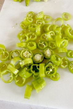 green peppers are cut up on a cutting board