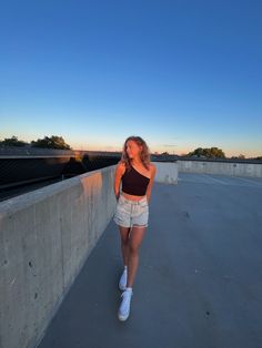 a woman is walking on the roof of a building