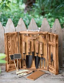 an open wooden box with gardening tools in it