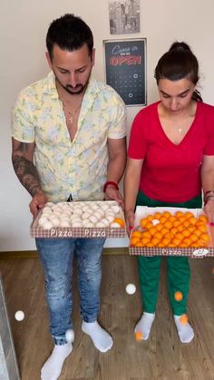 a man and woman holding trays of food