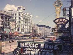 an old photo of a city street in the 1950's or early 1960s's