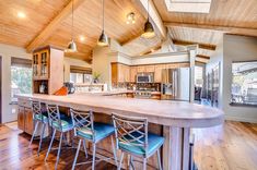 a large kitchen with an island in the middle and lots of counter space on one side