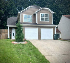 a large house with two garages in the front yard