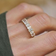 a woman's hand with a diamond ring on it