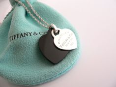 Offered for sale is a wonderful Tiffany classic. Whether you are just starting your Tiffany collection or are thinking of adding another piece, this one is perfect for you. Tiffany & Co.'s Sterling Silver & Onyx Double Heart necklace is a Tiffany classic that will never go out of style. It will most certainly be a piece that you will turn to over and over again, so it is great value for your money! It is a wonderful necklace that fits a lifestyle on the go -- the necklace can be worn to Double Heart Necklace, Gift Love, Double Heart, Tiffany Heart, Heart Charm Bracelet, Heart Pendant Necklace, Go Out, Out Of Style, Tiffany & Co.