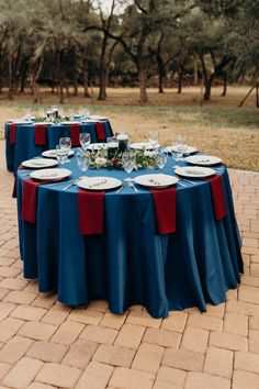 the table is set with plates and glasses