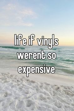 the words life fnvyls weren so expensive in front of an ocean beach