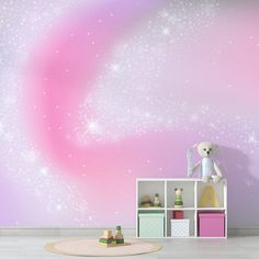 a pink and purple space themed wallpaper in a child's room with a teddy bear