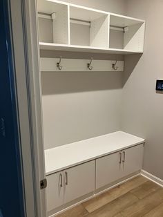 an empty room with some white cabinets and cupboards on the wall next to it