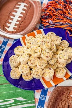 a plate full of food sitting on top of a table next to an american football