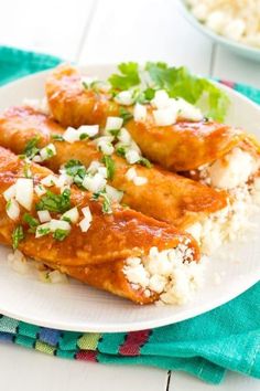 a white plate topped with chicken covered in sauce and rice