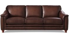 a brown leather couch sitting on top of a white floor