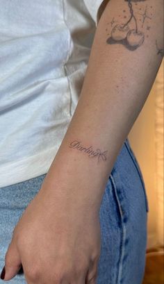 a woman's arm with a tattoo on it that reads, i love you